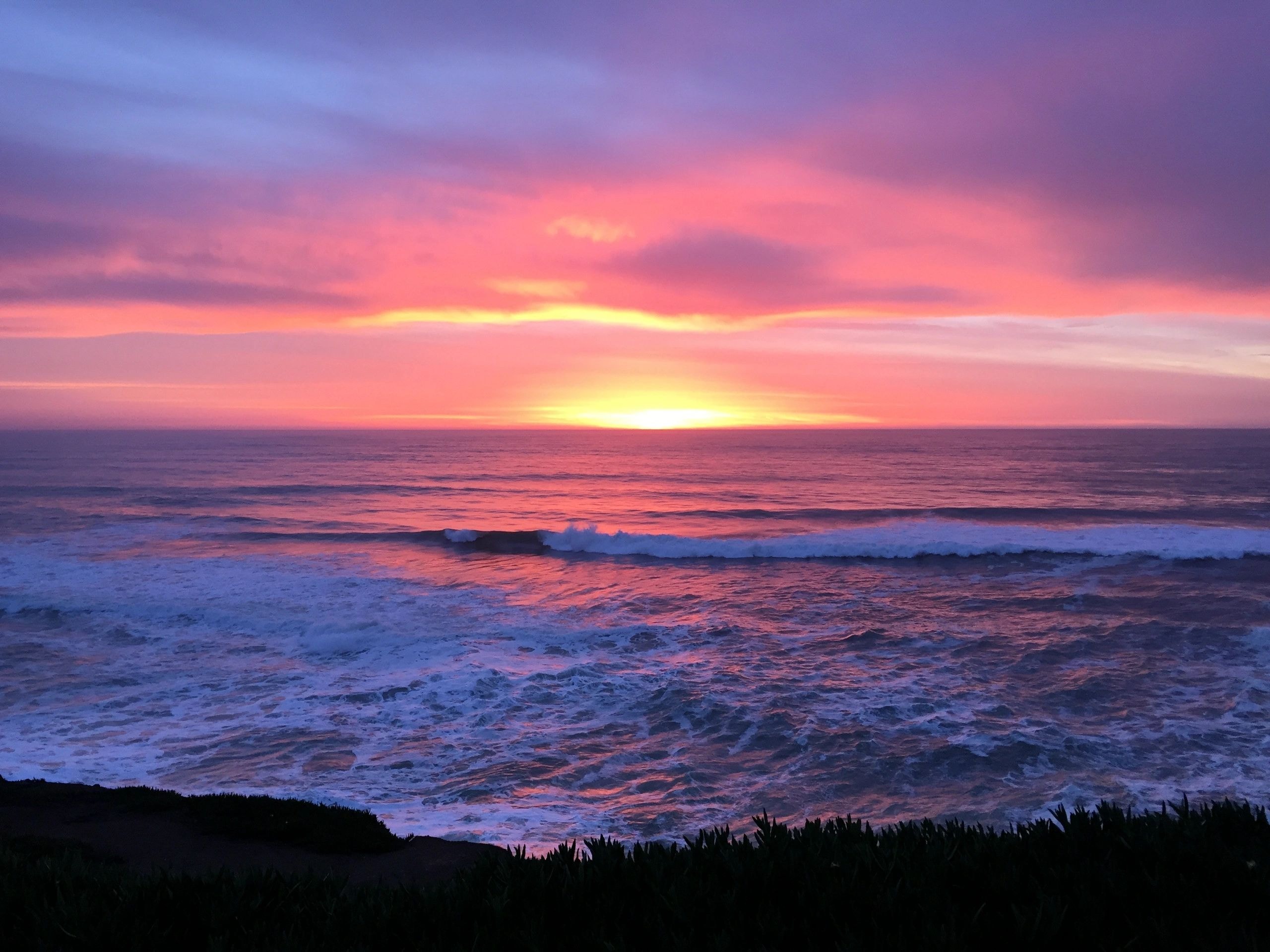 Sunset over ocean waves coastal
