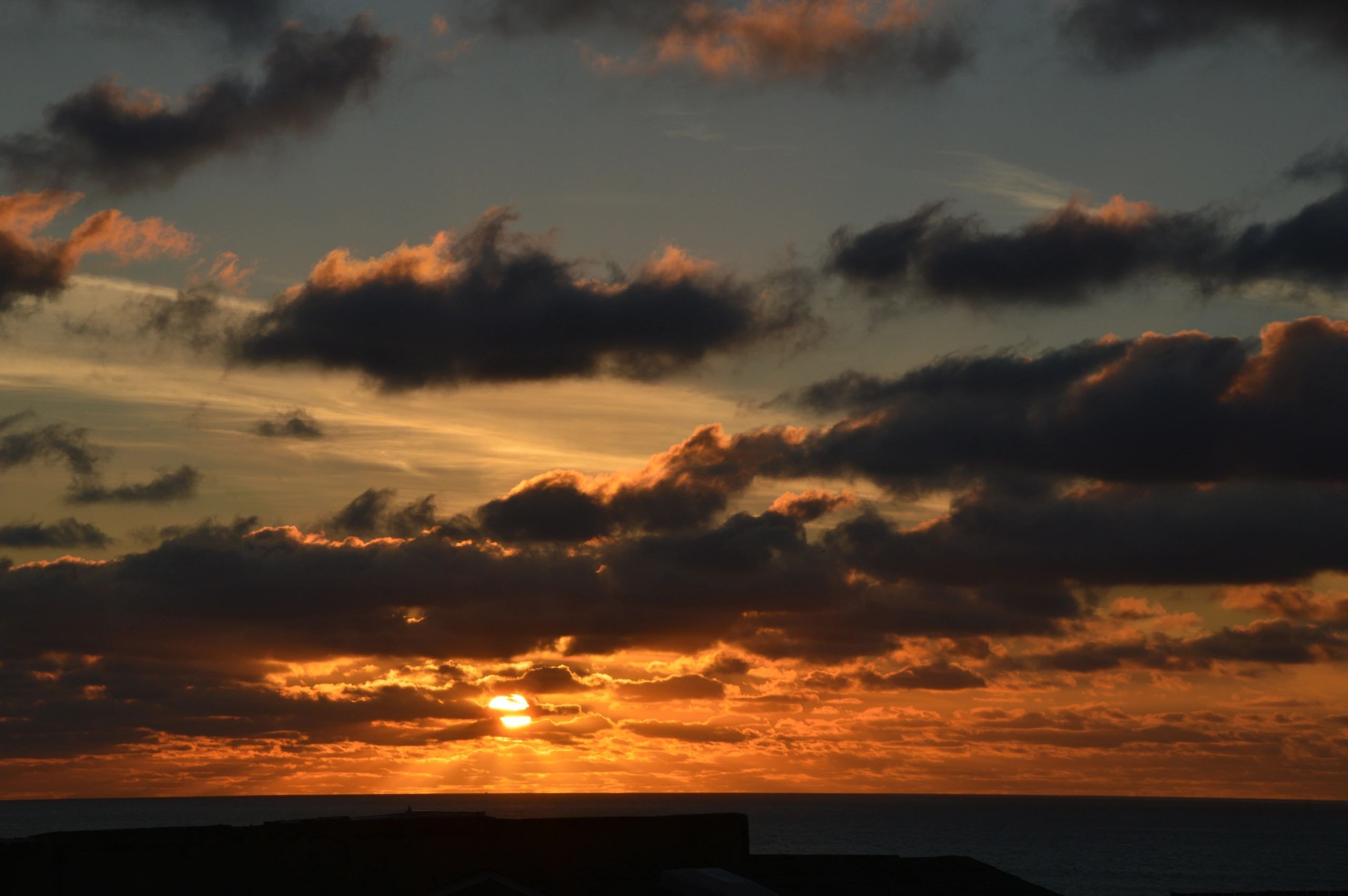 Dramatic sunset over ocean clouds